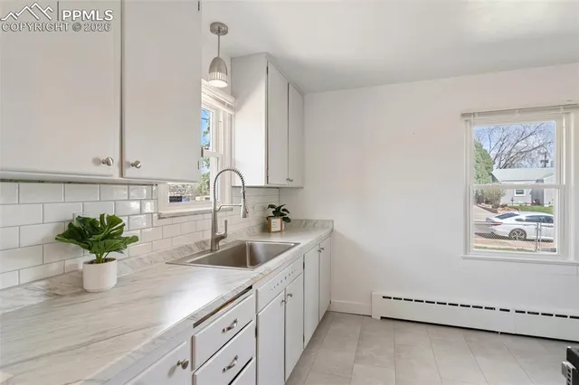 a kitchen that has a sink and a stove top oven