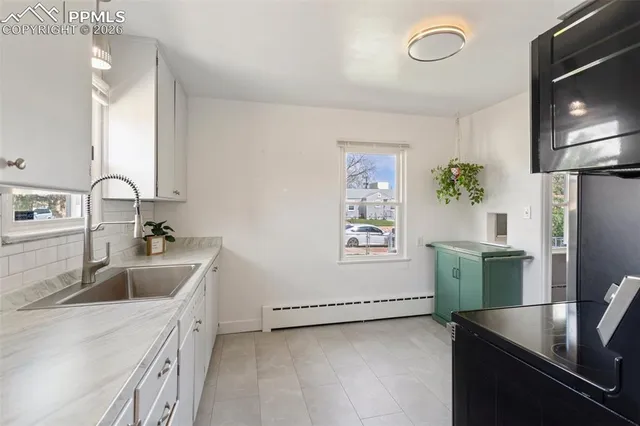 a kitchen with granite countertop a refrigerator and a stove