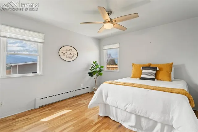 a bedroom with a bed and a painting on the wall