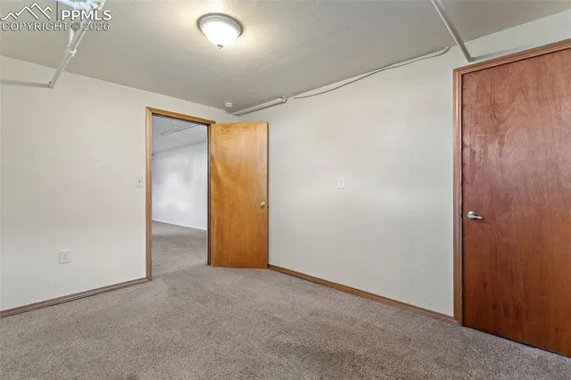 a view of backyard with seating space and wooden fence