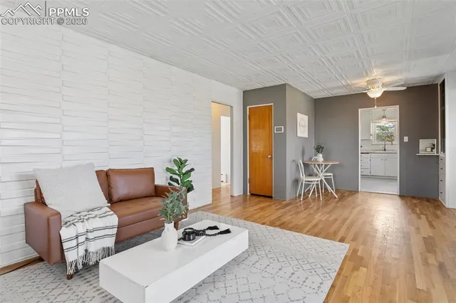 a living room with furniture and wooden floor