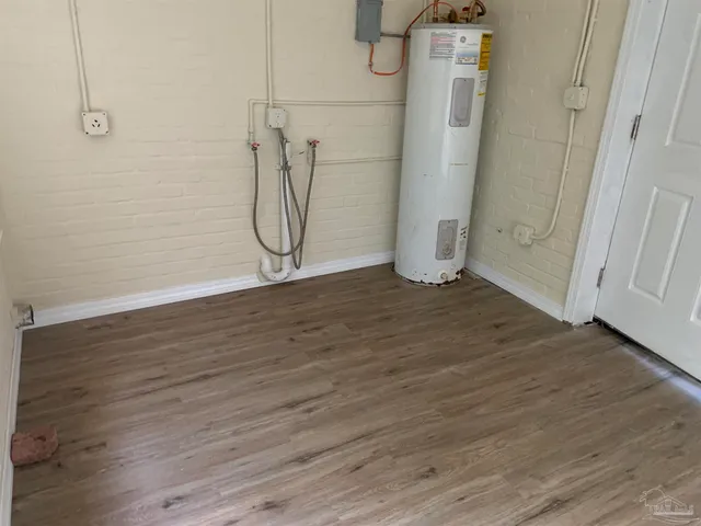 a view of a room with wooden floor and white walls