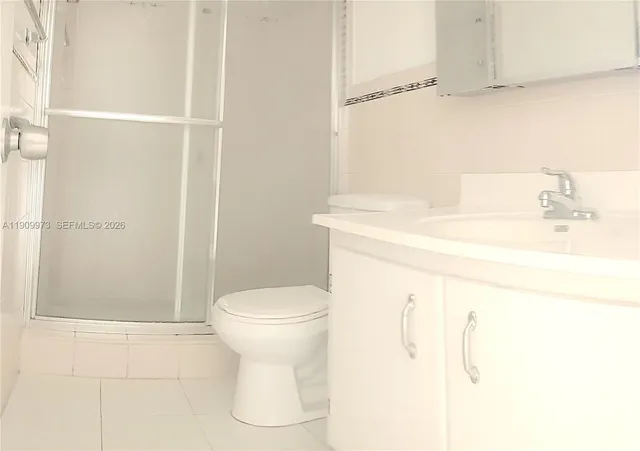 a kitchen with a stove top oven and cabinets