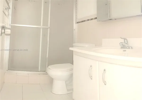 a kitchen with a stove top oven and cabinets