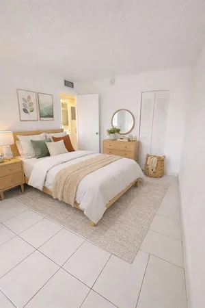 a bedroom with a bed and a lamp