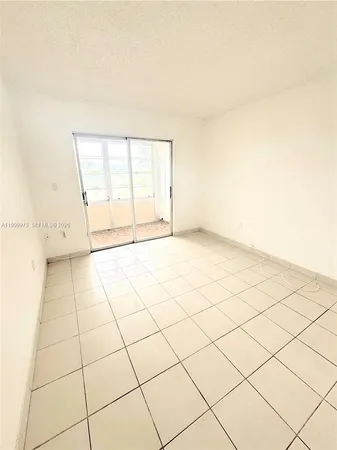 a view of a room with wooden floor and a window