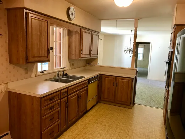 a kitchen with a sink and a refrigerator