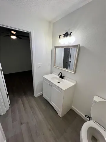 a bathroom with a sink vanity and mirror