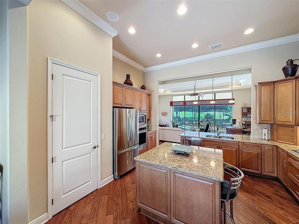 1542 North Ridge Meadow Path Hernando, FL 34442 - Photo 12 of 38 a kitchen with a refrigerator and a sink