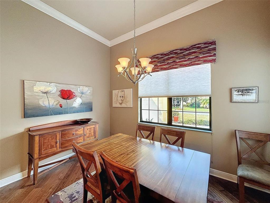 1542 North Ridge Meadow Path Hernando, FL 34442 - Photo 14 of 38 a view of a dining room with furniture and a chandelier
