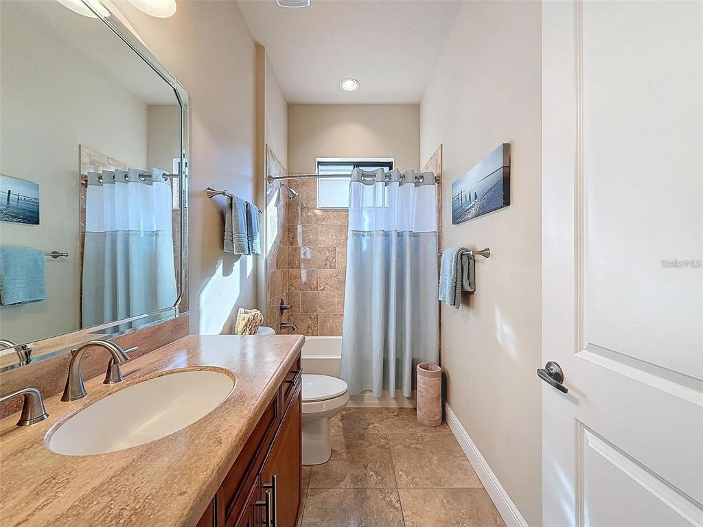 1542 North Ridge Meadow Path Hernando, FL 34442 - Photo 23 of 38 a bathroom with a granite countertop sink a mirror and shower