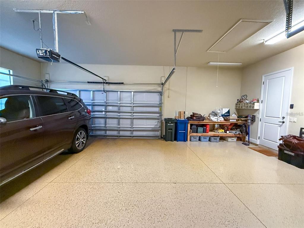 1542 North Ridge Meadow Path Hernando, FL 34442 - Photo 28 of 38 a view of parking garage with furniture and a garage