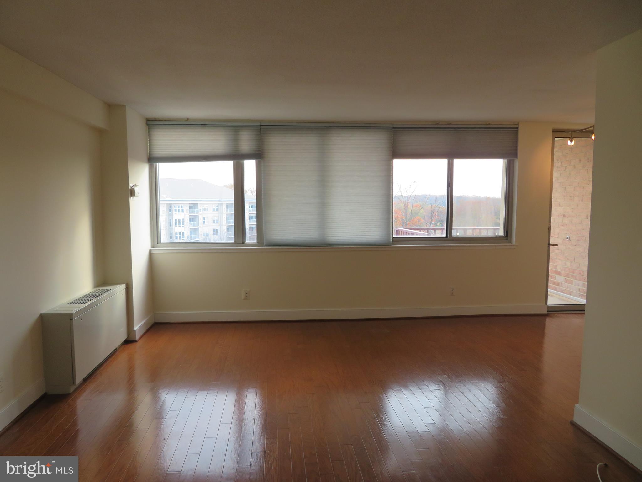 1220 Blair Mill Road, Unit 809 Silver Spring, MD 20910 - Photo 28 of 66 an empty room with wooden floor and windows