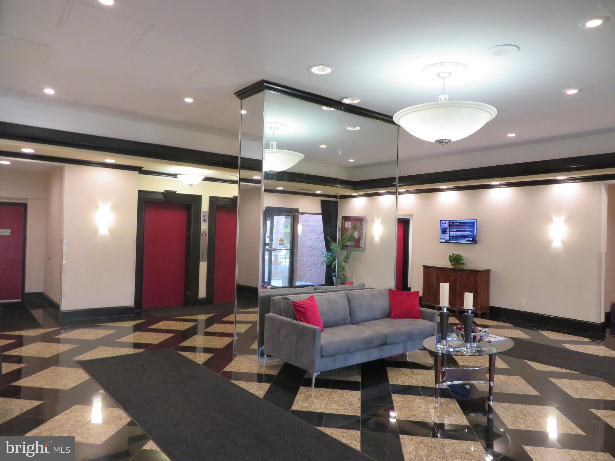 1220 Blair Mill Road, Unit 809 Silver Spring, MD 20910 - Photo 5 of 66 a living room with furniture and a flat screen tv