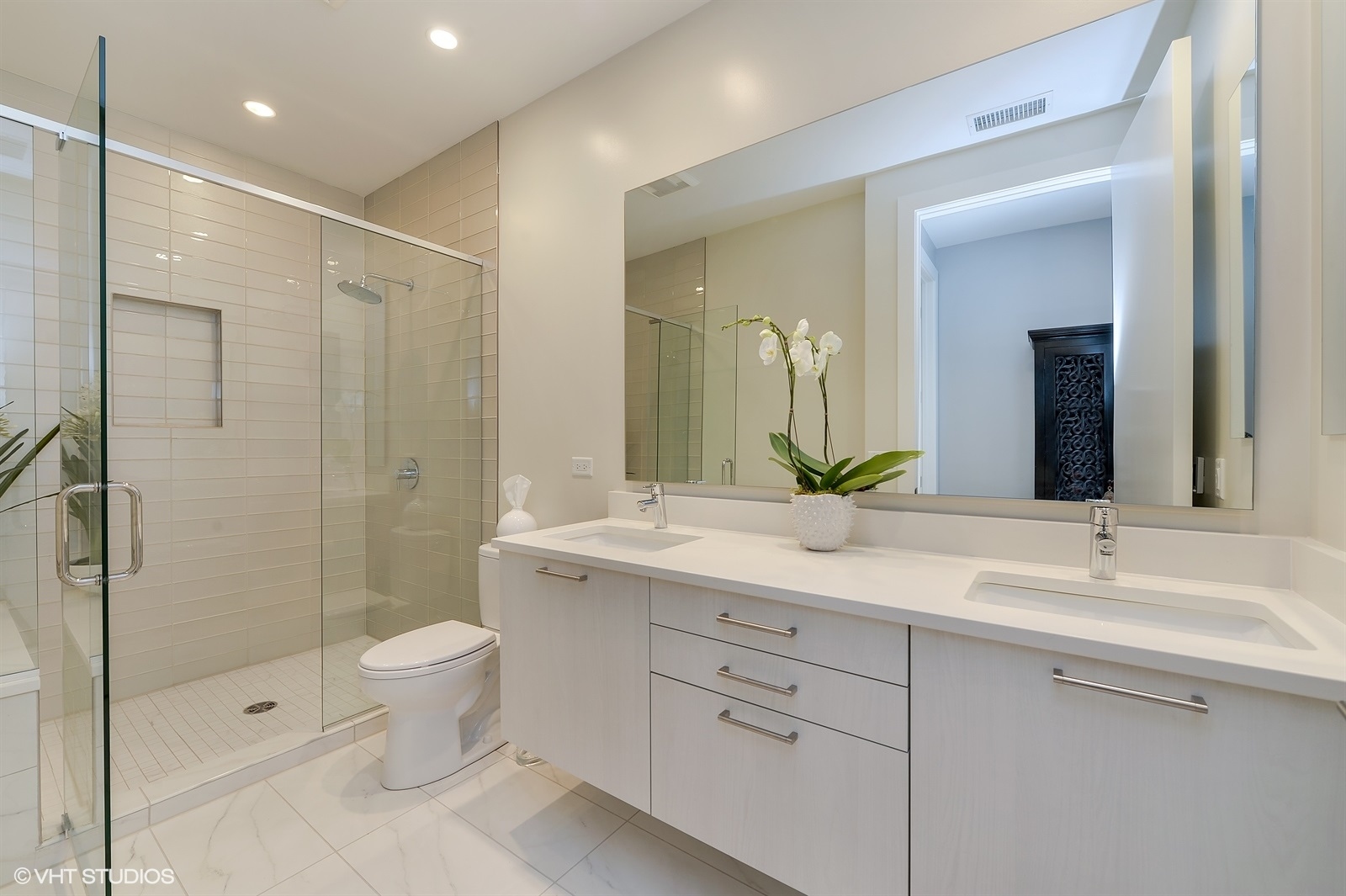 367 West Locust Street, Unit 606 Chicago, IL 60610 - Photo 13 of 24 a bathroom with a double vanity sink toilet and shower