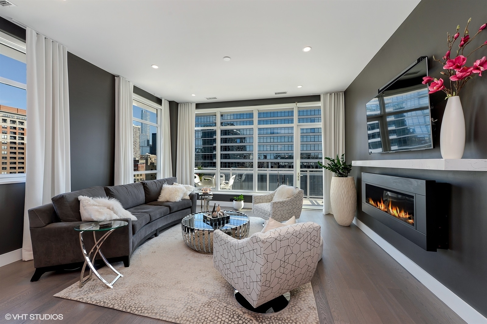 367 West Locust Street, Unit 606 Chicago, IL 60610 - Photo 4 of 24 a living room with furniture a fireplace and a floor to ceiling window