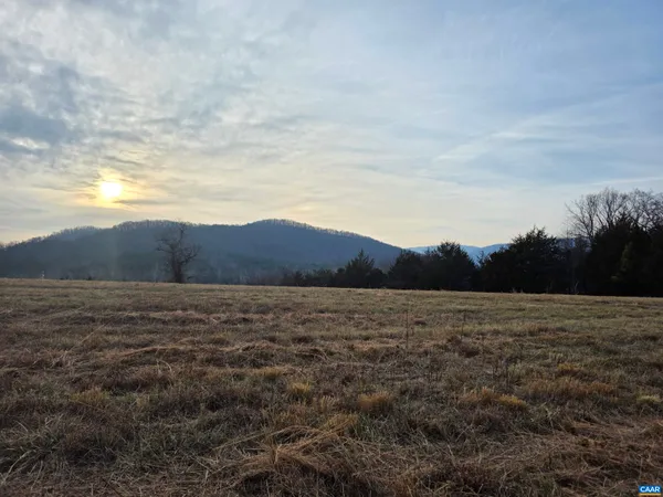a view of an ocean beach and mountains