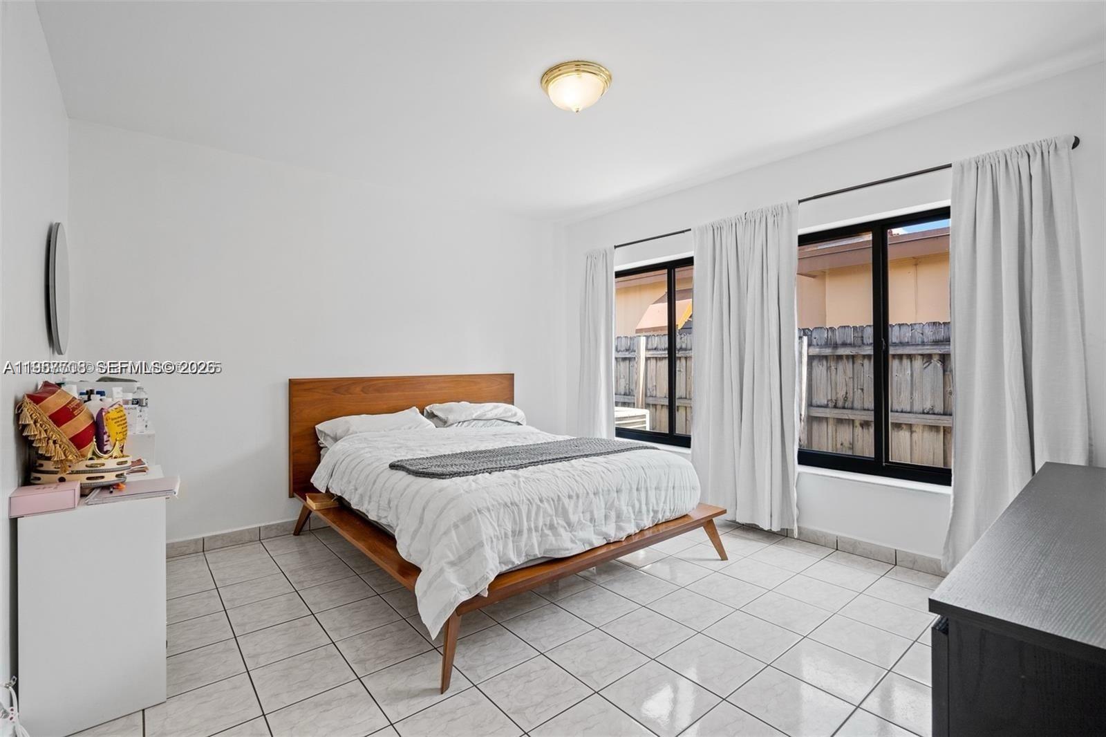 6418 Southwest 39th Terrace Miami, FL 33155 - Photo 15 of 24 a bedroom with a bed and a window