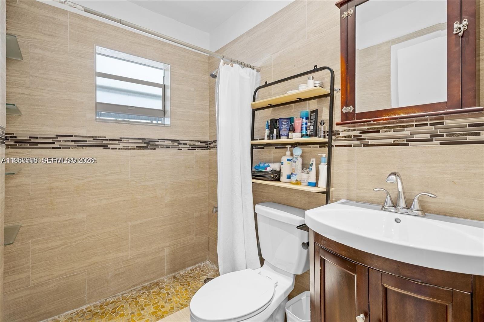 6418 Southwest 39th Terrace Miami, FL 33155 - Photo 17 of 24 a bathroom with a sink a toilet and shower