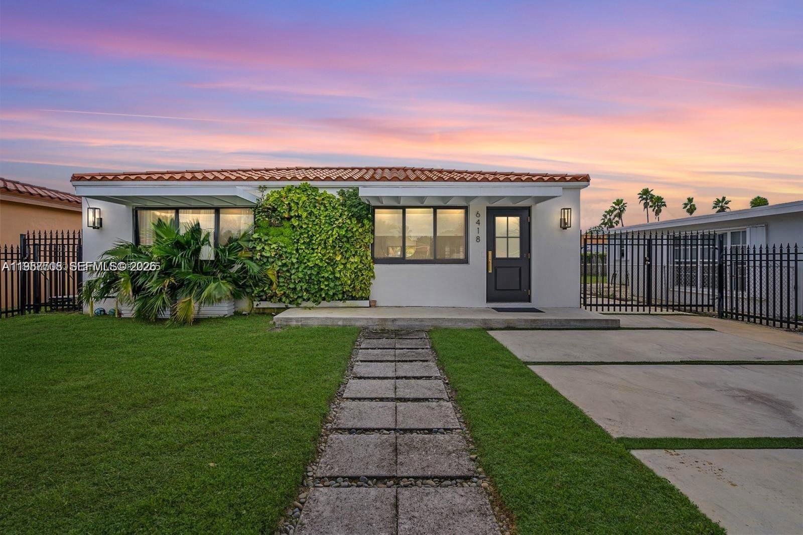 6418 Southwest 39th Terrace Miami, FL 33155 - Photo 2 of 24 a front view of a house with garden