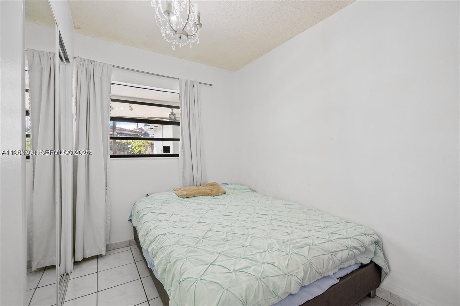 6418 Southwest 39th Terrace Miami, FL 33155 - Photo 21 of 24 a bedroom with a bed and a window