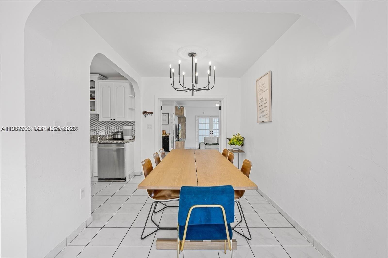 6418 Southwest 39th Terrace Miami, FL 33155 - Photo 7 of 24 a dining room with furniture a chandelier and kitchen view