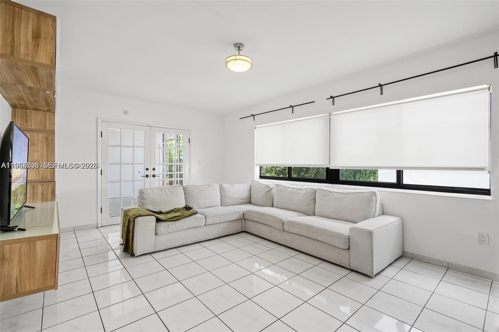6418 Southwest 39th Terrace Miami, FL 33155 - Photo 10 of 24 a living room with furniture and a large window