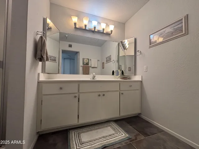 a bathroom with a sink a toilet and mirror