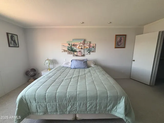 a bedroom with a bed and a chandelier