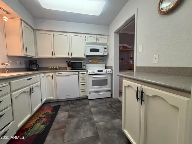 a kitchen with a stove sink and cabinets