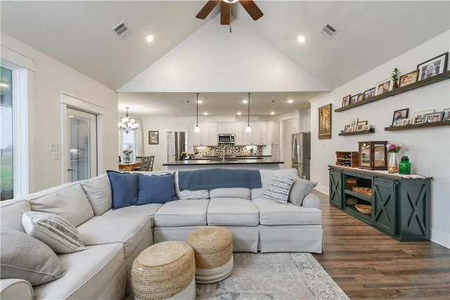 a living room with furniture and kitchen view