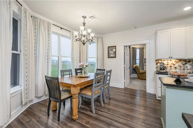 a view of a dining room with furniture and chandelier