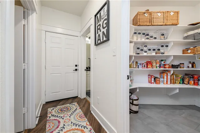 a kitchen with granite countertop a sink a counter space appliances and cabinets