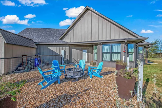 a living room with furniture and large windows
