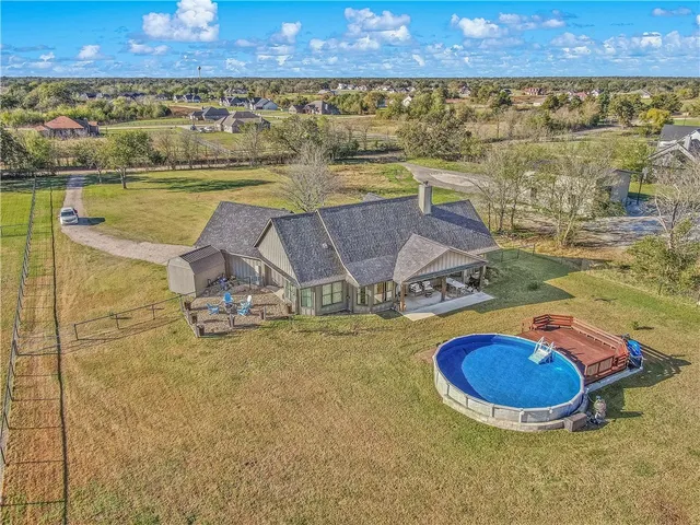 a view of house with backyard outdoor seating and patio