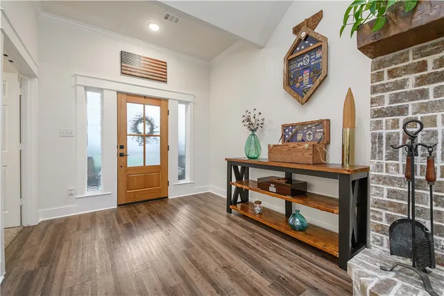 a view of an entryway with wooden floor