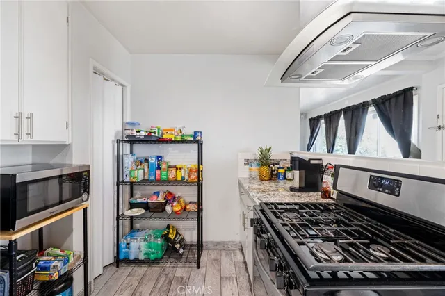 a kitchen with stainless steel appliances granite countertop a refrigerator and a stove