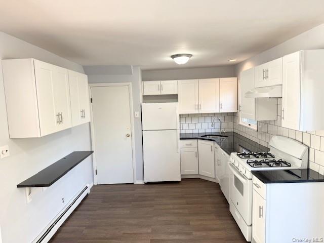 10 Revere Road Port Washington, NY 11050 - Photo 2 of 17 a kitchen with stainless steel appliances a refrigerator a stove a sink and white cabinets