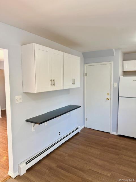 10 Revere Road Port Washington, NY 11050 - Photo 4 of 17 a view of a kitchen with wooden floor and cabinets