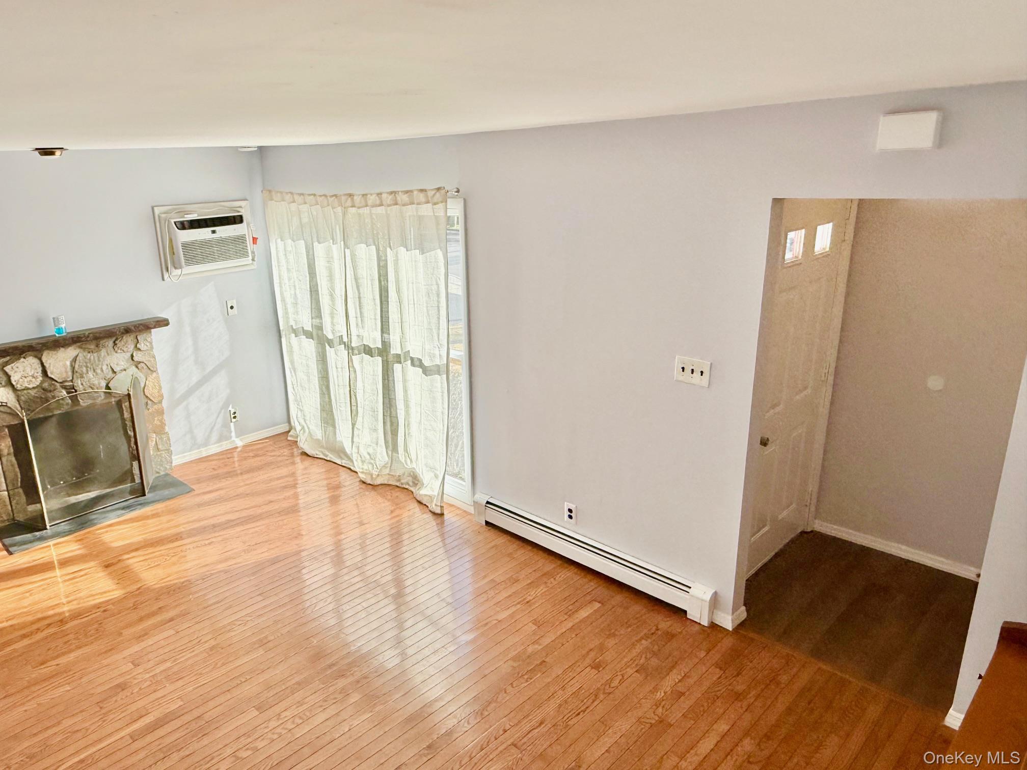 10 Revere Road Port Washington, NY 11050 - Photo 7 of 17 an empty room with wooden floor and windows