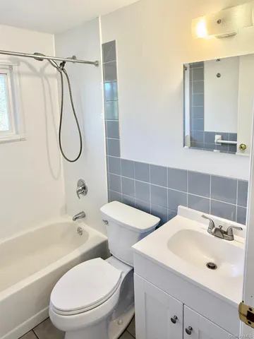 a bathroom with a toilet sink shower and mirror