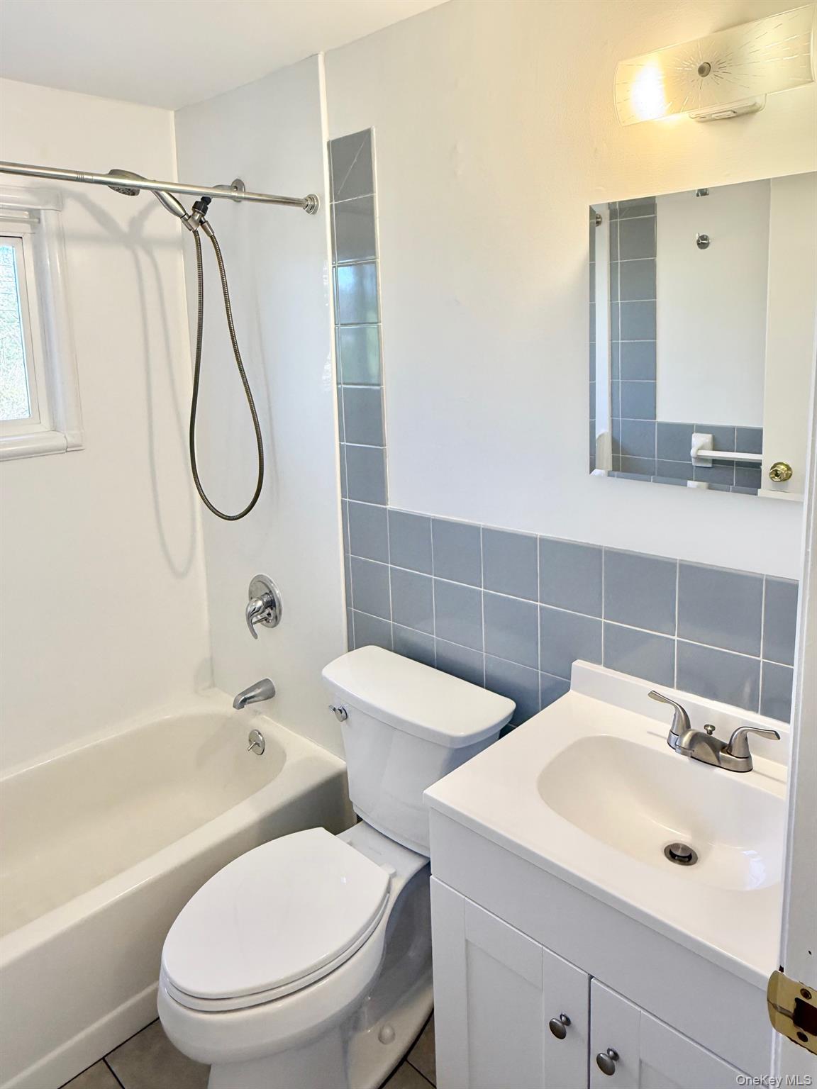 10 Revere Road Port Washington, NY 11050 - Photo 8 of 17 a bathroom with a toilet sink shower and mirror