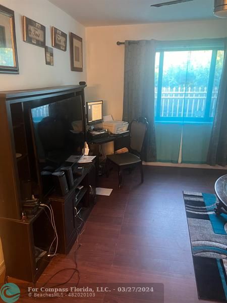 281 Northwest 52nd Street Miami, FL 33127 - Photo 12 of 28 a living room with furniture and a flat screen tv