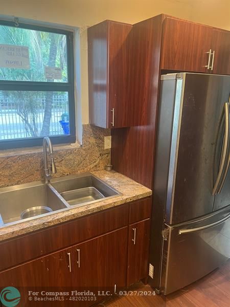 281 Northwest 52nd Street Miami, FL 33127 - Photo 14 of 28 a kitchen with a sink and a refrigerator