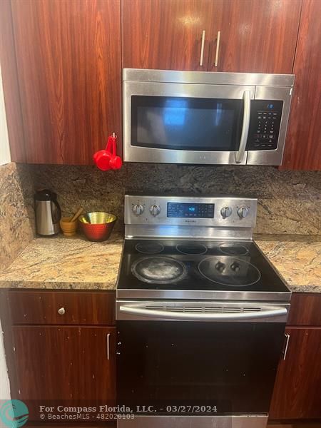 281 Northwest 52nd Street Miami, FL 33127 - Photo 15 of 28 a kitchen with granite countertop a stove and microwave