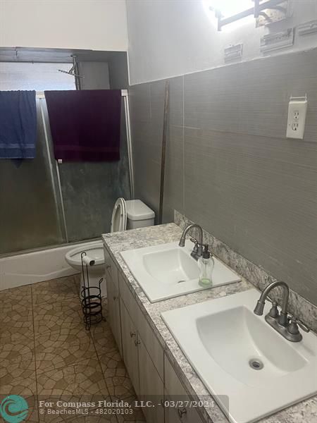 281 Northwest 52nd Street Miami, FL 33127 - Photo 19 of 28 a bathroom with a sink and a mirror
