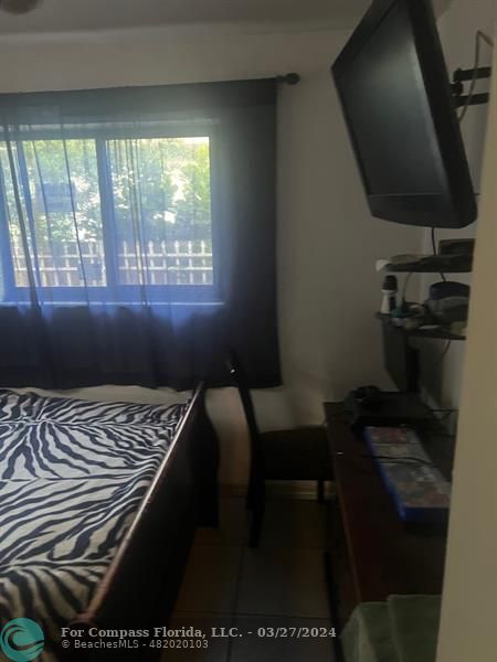 281 Northwest 52nd Street Miami, FL 33127 - Photo 21 of 28 a bedroom with a bed and a window