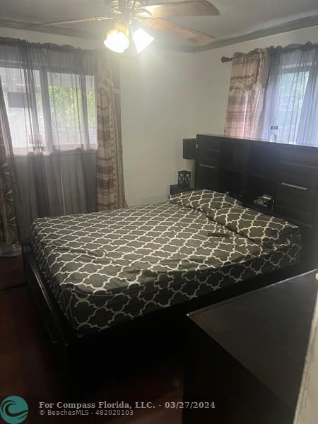 281 Northwest 52nd Street Miami, FL 33127 - Photo 28 of 28 a bed sitting in a bedroom next to a window