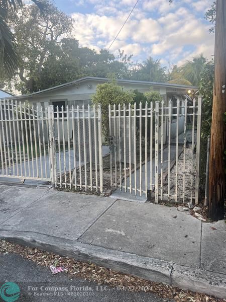 281 Northwest 52nd Street Miami, FL 33127 - Photo 4 of 28 a view of a wrought fence