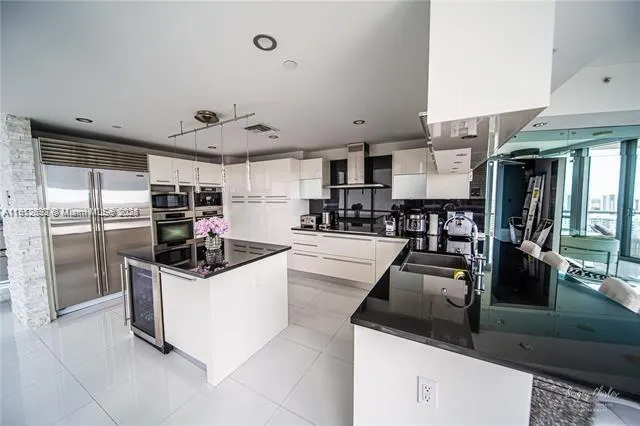 a kitchen with counter top space and stainless steel appliances